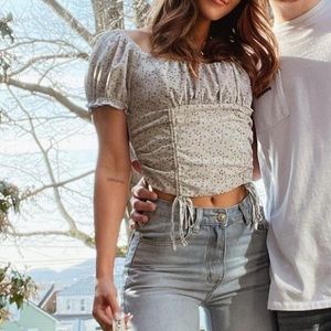 Slightly cropped light blue puff sleeve shirt with light purple floral detailing